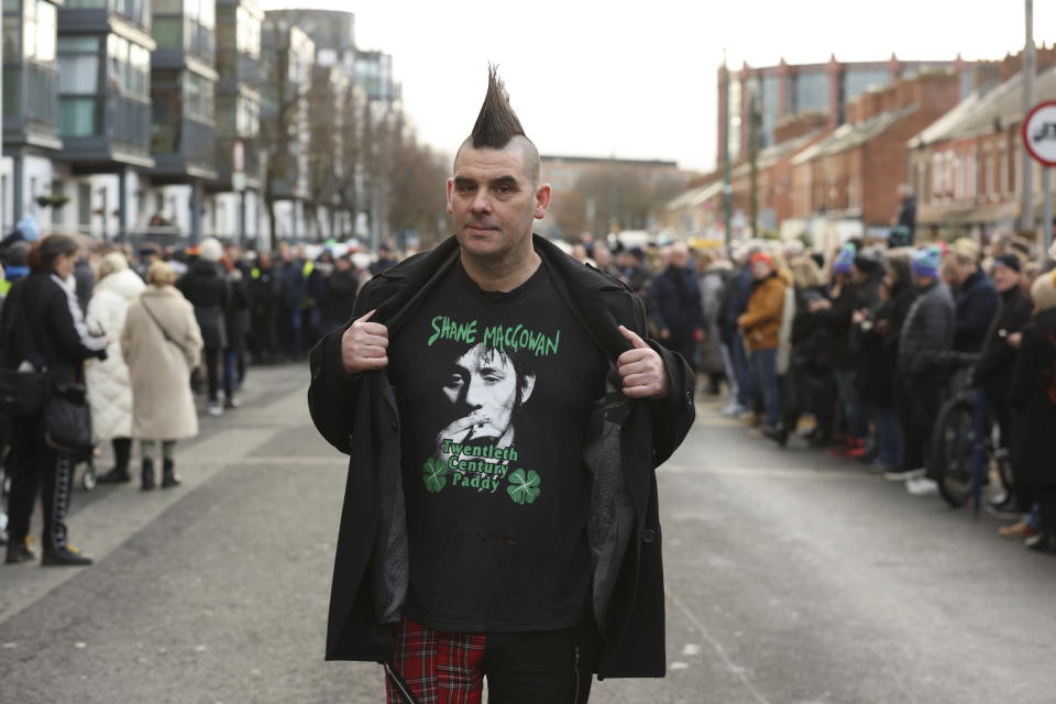 John Farrell outside Shelbourne Park Stadium in waits for the funeral procession of Shane MacGowan to makes its way through the streets of Dublin ahead of his funeral in Co Tipperary, in Ireland, Friday, Dec. 8, 2023. MacGowan, the singer-songwriter and frontman of The Pogues, best known for their ballad “Fairytale of New York,” died on Thursday, Nov. 30, 2023. He was 65. (Liam McBurney/PA via AP)