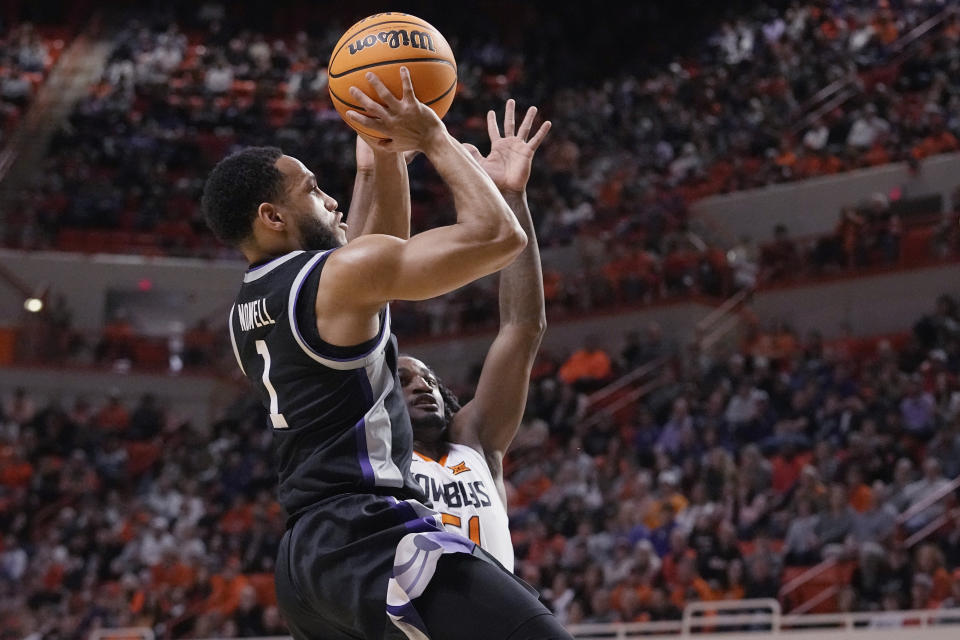 Kansas State guard Markquis Nowell (1) shoots in front of Oklahoma State guard John-Michael Wright, right, in the first half of an NCAA college basketball game, Saturday, Feb. 25, 2023, in Stillwater, Okla. (AP Photo/Sue Ogrocki)