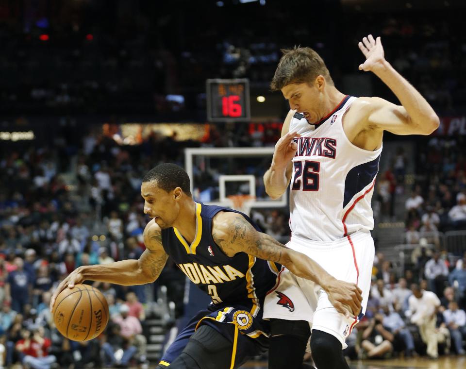 Indiana Pacers guard George Hill (3) drives against Atlanta Hawks guard Kyle Korver (26) in the first half of Game 3 of an NBA basketball first-round playoff series on Thursday, April 24, 2014, in Atlanta. The Hawks won 98-85. (AP Photo/John Bazemore)