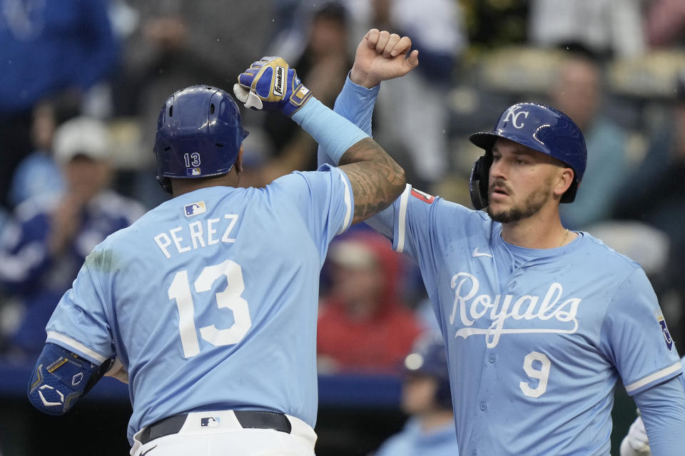 Kansas City Royals' Salvador Perez (13) celebrates with Vinnie Pasquantino (9) after they scored on Perez's two-run home run during the first inning of a baseball game against the Toronto Blue Jays Thursday, April 25, 2024, in Kansas City, Mo. (AP Photo/Charlie Riedel)