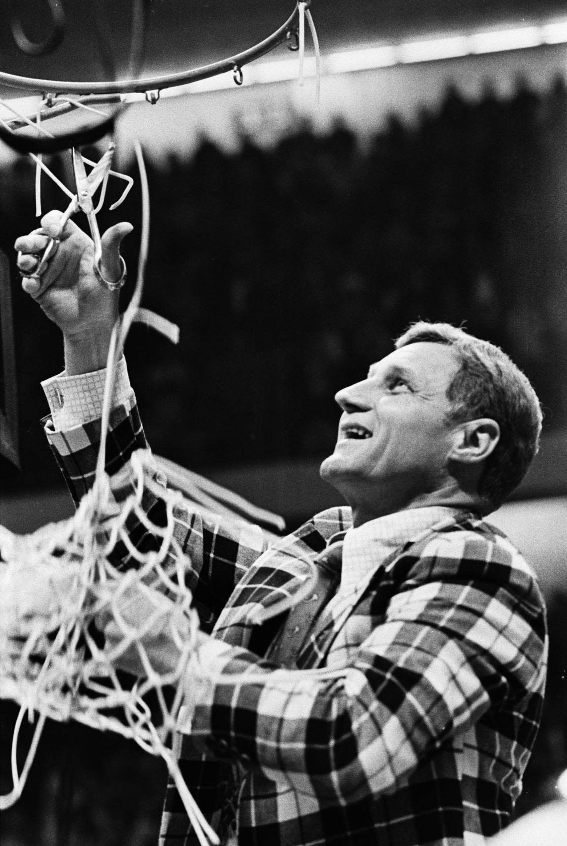 NC State head coach Norm Sloan cuts down the nets after his Wolfpack defeated Marquette to win the 1974 National Championship.