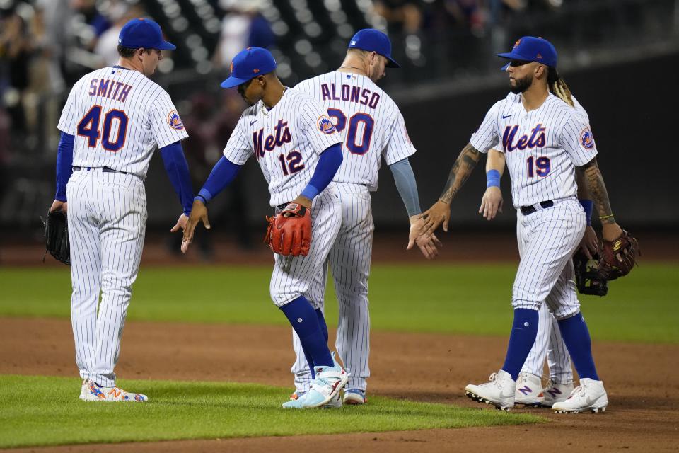 New York Mets relief pitcher Drew Smith (40) celebrates with Francisco Lindor (12), Pete Alonso (20) and Jonathan Arauz (19) after the team's 7-1 win in a baseball game against the Arizona Diamondbacks, Wednesday, Sept. 13, 2023, in New York. (AP Photo/Frank Franklin II)