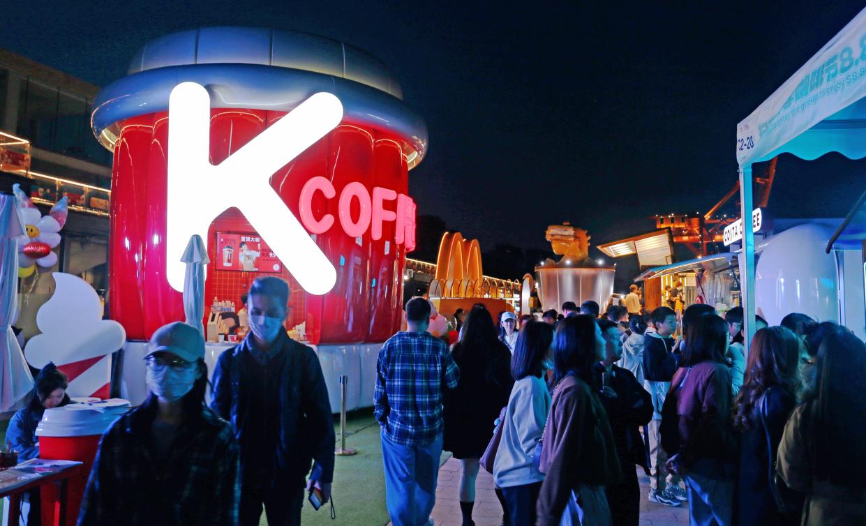 Visitors visit the KFC stand at a market in Shanghai.