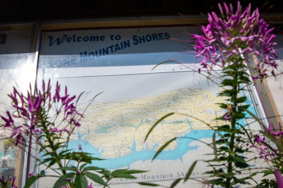 A sign and lot map welcomes people to Lone Mountain Shores at the community's entrance in New Tazewell on Wednesday, July 26, 2023.
