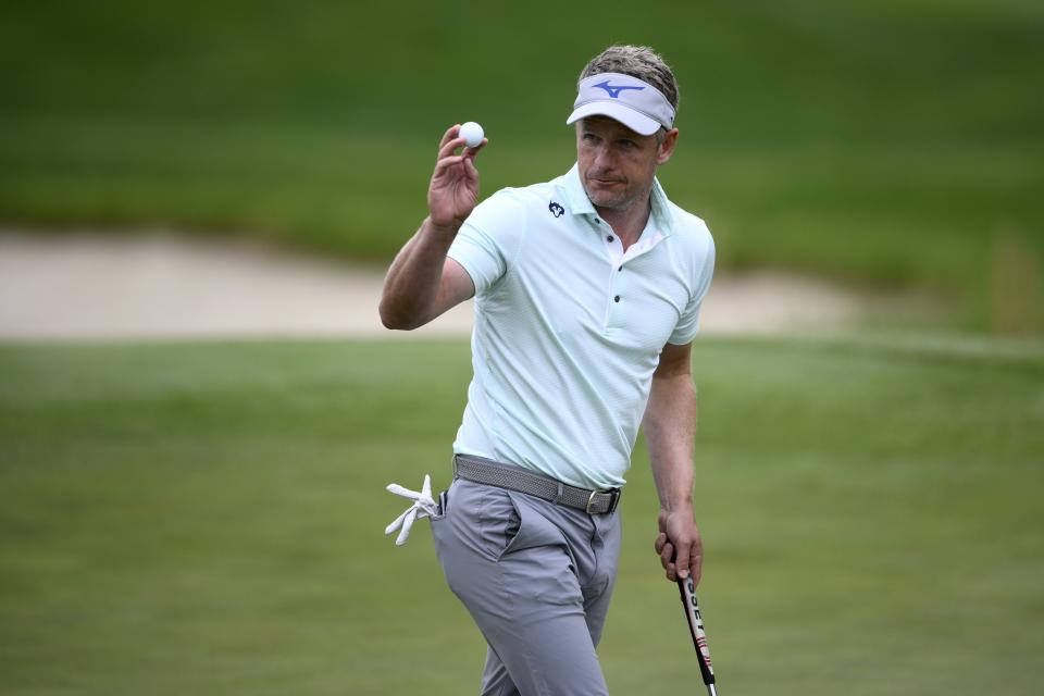 FILE - Luke Donald, of England, acknowledges the gallery after his putt on the 18th green during the first round of the Wells Fargo Championship golf tournament, on May 5, 2022, at TPC Potomac at Avenel Farm golf club in Potomac, Md. This year’s Ryder Cup is set to mark a break from the past for European golf and this week might provide a hint as to who is part of the future. The Hero Cup match-play event takes place in Abu Dhabi from Friday Jan. 13, to Sunday Jan. 15, 2023. (AP Photo/Nick Wass, File)