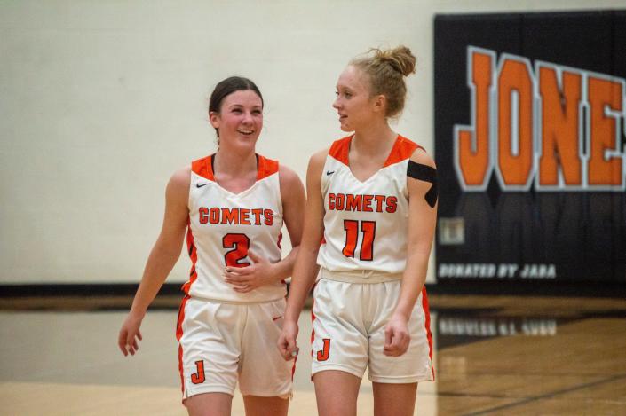 Comet basketball players Reese Stanton (2) and Kierstyn Keller (11) wait for the game to resume in the fourth quarter.
