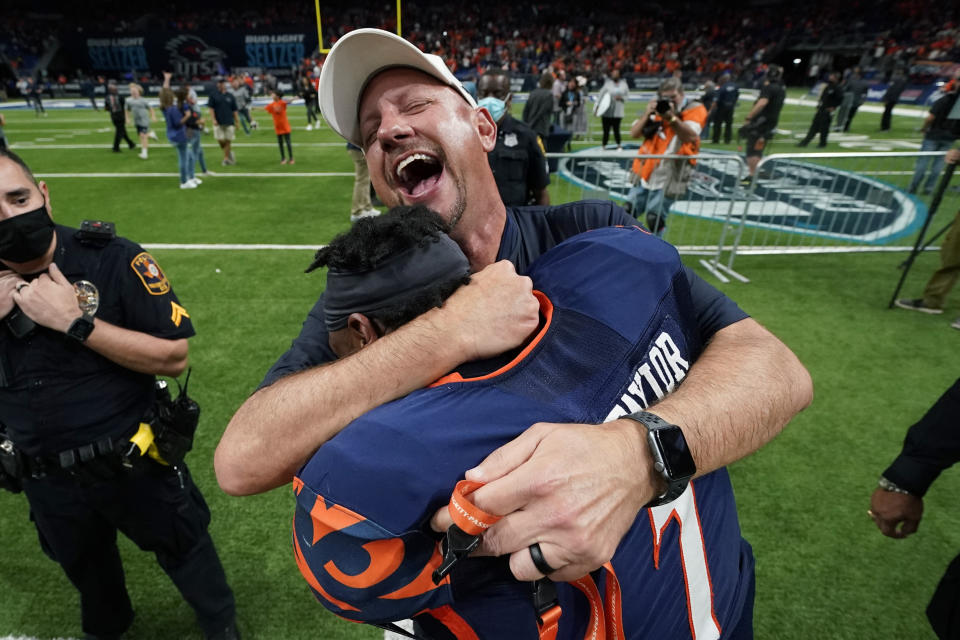 UTSA head coach Jeff Traylor celebrates his team's win over Western Kentucky with safety Dadrian Taylor (7) in an NCAA college football game in the Conference USA Championship, Friday, Dec. 3, 2021, in San Antonio. (AP Photo/Eric Gay)