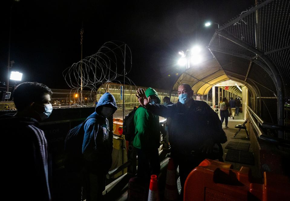 A Customs and Border Protection officer stops the line at the entry point to the U.S. on the Paso Del Norte International bridge as Mexicans with U.S. tourists line up prior to the reopening of the border on Nov. 7, 2021.