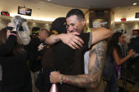 San Diego Padres' Manny Machado hugs a teammate after clinching a wild-card playoff spot following a baseball game against the Chicago White Sox, Sunday, Oct. 2, 2022, in San Diego. (AP Photo/Derrick Tuskan)