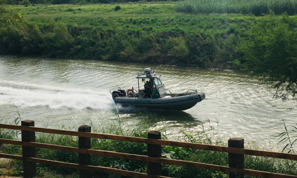 A US border patrol boat navigates the Rio Grande near where the bodies of migrant Oscar Alberto Martínez Ramírez and his daughter Valeria were found, in Matamoros, Mexico, on 24 June.