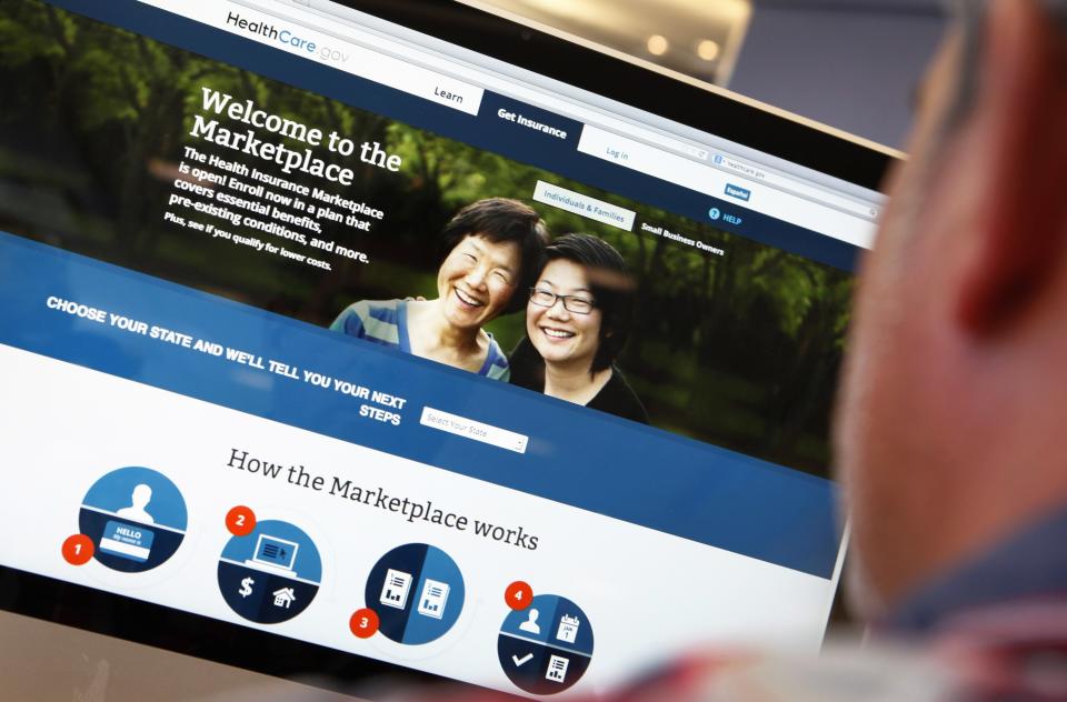 A man looks over the Affordable Care Act (commonly known as Obamacare) signup page on the HealthCare.gov website in New York in this October 2, 2013 photo illustration. A crucial weekend for the troubled website that is the backbone of President Barack Obama's healthcare overhaul appears to be off to a shaky start, as the U.S. government took the HealthCare.gov site offline for an unusually long maintenance period into Saturday morning. REUTERS/Mike Segar/Files (UNITED STATES - Tags: HEALTH POLITICS)