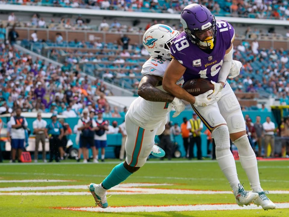 Adam Thielen catches a touchdown against the Miami Dolphins.