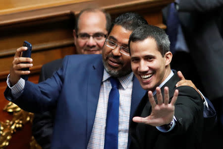 Venezuelan opposition leader and self-proclaimed interim president Juan Guaido gestures as he attends a session of the Venezuela's National Assembly in Caracas, Venezuela January 29, 2019. REUTERS/Carlos Garcia Rawlins