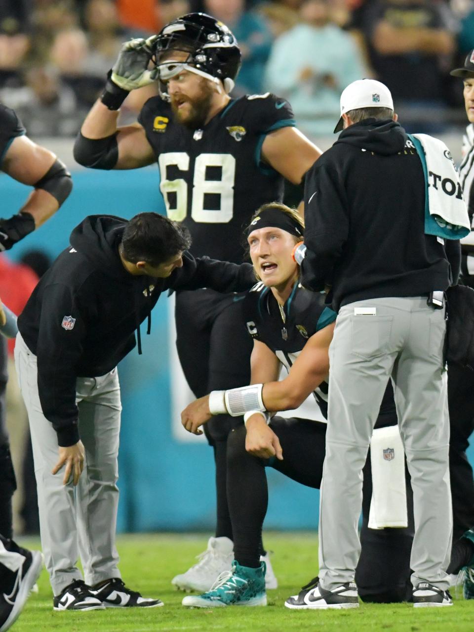 Jacksonville Jaguars quarterback Trevor Lawrence (16) is tended to after a fourth quarter ankle injury took him out of the game. The Jacksonville Jaguars hosted the Cincinnati Bengals at EverBank Stadium in Jacksonville, Florida for Monday Night Football, December 4, 2023. The Jaguars were tied 14 to 14 at the end of the first half an fell in overtime with a final score of 34 to 31. [Bob Self/Florida Times-Union]