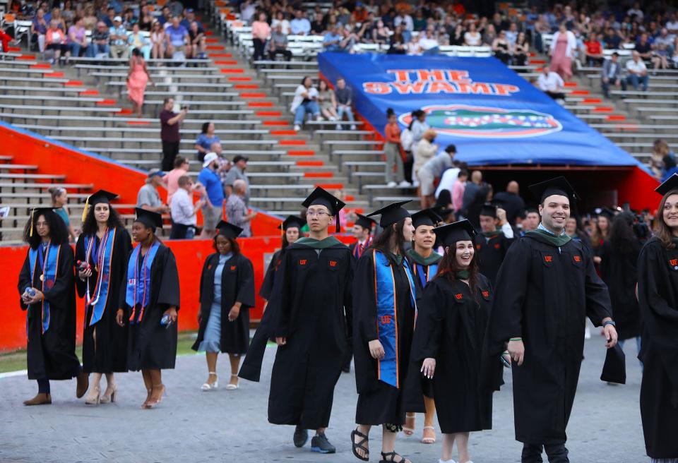 University of Florida graduates enter the Spring 2022 Commencement Ceremony being held at Ben Hill Griffin Stadium, in Gainesville Fla. April 29, 2022. Florida Gators great Tim Tebow was the commencement speaker. He talked about not just being successful, but being sure that you were being significant.