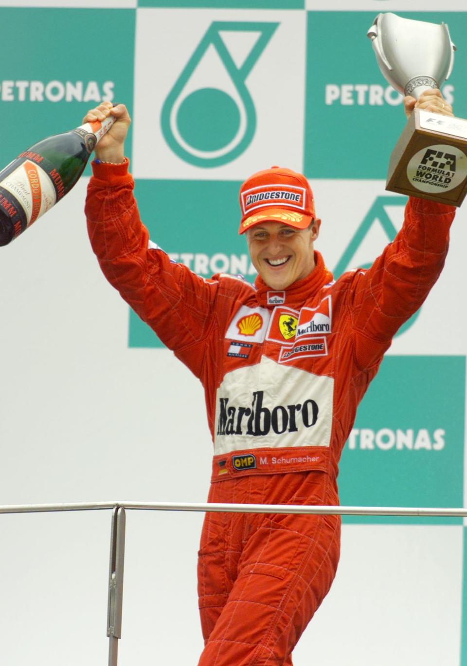 Schumacher celebrates on the podium after winning the Malaysian Grand Prix at the Sepang F1 Circuit. (Reuters)