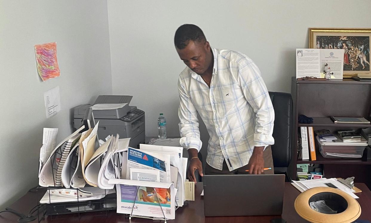 <span>Bansal Oreus helps other Haitian immigrants with government documents at the St Vincent de Paul Society in Springfield, Ohio, last month.</span><span>Photograph: Howard Schneider/Reuters</span>