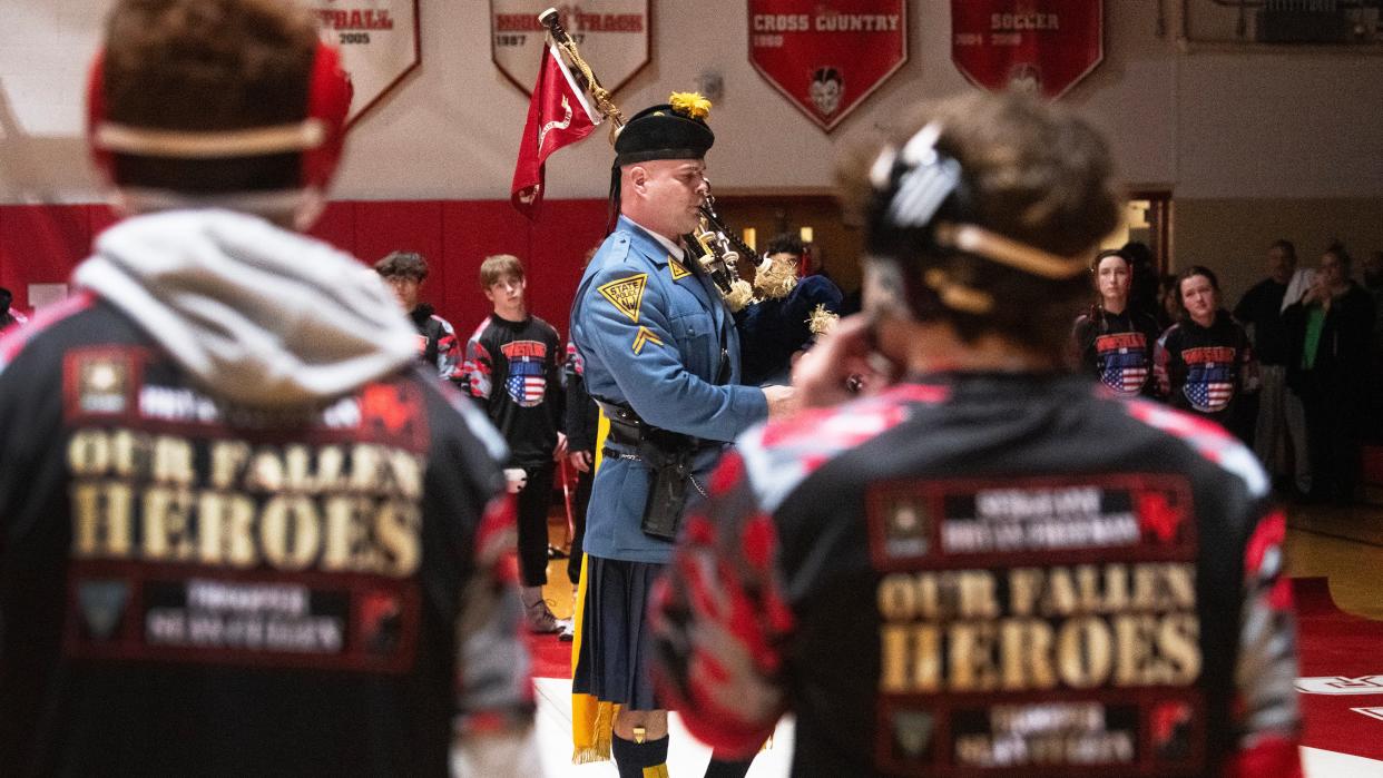 New Jersey State Trooper Jeff Bowman plays the bagpipes during a ceremony held prior to the 7th Annual Wrestling for Heroes Match at Rancocas Valley High School on Wednesday, January 24, 2024.