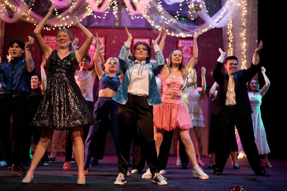 Kylie Scarpace as Alyssa, left front, and Elise Brown as Emma, light blue jacket, lead the cast in a song from “The Prom” at the Croswell Opera House.