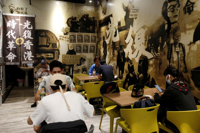 People eat lunch at Aegis, a restaurant that offer work opportunities to Hong Kongers seeking asylum in Taipei,