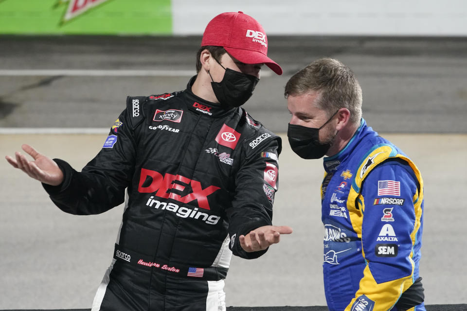 Harrison Burton, left, talks with Justin Allgaier before the NASCAR Xfinity Series auto race at Martinsville Speedway in Martinsville, Va., Friday, April 9, 2021. (AP Photo/Steve Helber)