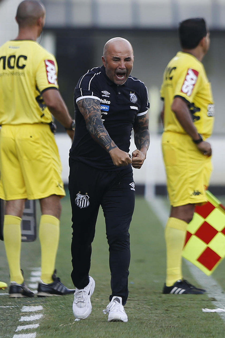 Jorge Sampaoli, coach of Santos, celebrates after the first goal during a Sao Paulo Soccer league championship match against Ferroviaria in Santos, Brazil, Saturday, Jan. 19, 2019. It's the first match of the coach Sampaoli, of Argentina, as head of the legendary Santos Soccer team. (AP Photo/Nelson Antoine)