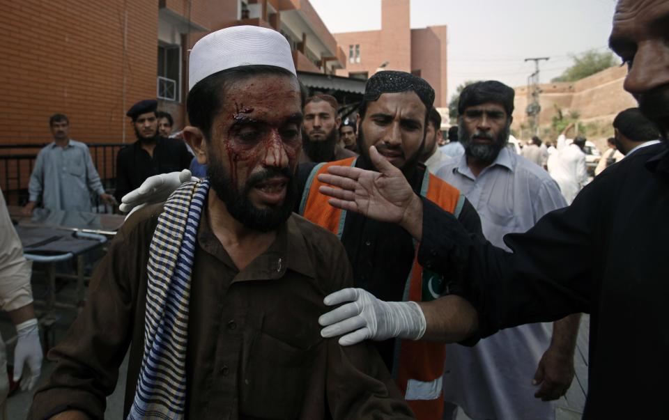 A man who was injured during a bomb blast arrives at a hospital in Peshawar September 29, 2013. Twin blasts in the northwestern Pakistan city of Peshawar killed 33 people and wounded 70 on Sunday, a week after two bombings at a church in the frontier city killed scores, police and hospital authorities said.REUTERS/ Fayaz Aziz (PAKISTAN - Tags: POLITICS CIVIL UNREST CRIME LAW)