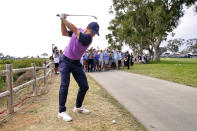 Rory McIlroy, of Northern Ireland, hits from alongside the cart path on the 15th fairway during the third round of the U.S. Open Golf Championship, Saturday, June 19, 2021, at Torrey Pines Golf Course in San Diego. (AP Photo/Jae C. Hong)