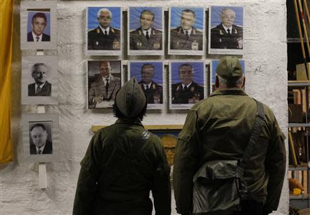 A couple dressed as NVA soldiers look at photos at the 'Bunker-Museum' in Rennsteighoehe near the eastern city of Ilmenau October 12, 2013. REUTERS/Ina Fassbender