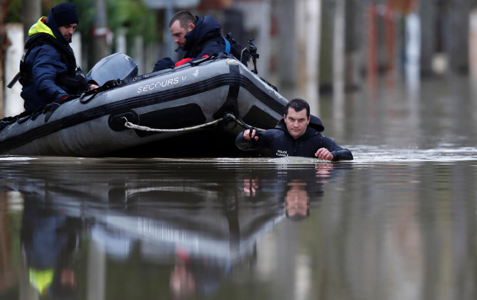 <p>Paris police divers use a small boat to patrol a flooded street of a residential area in Villeneuve-Saint-Georges, near Paris, France, Jan. 25, 2018. (Photo: Christian Hartmann/Reuters) </p>