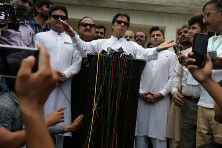 Cricket star-turned-politician Imran Khan, chairman of Pakistan Tehreek-e-Insaf (PTI), speaks to members of media after casting his vote at a polling station during the general election in Islamabad, Pakistan, July 25, 2018. REUTERS/Athit Perawongmetha