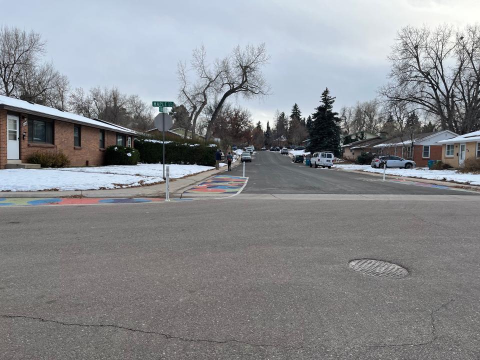 An asphalt art project at Maple Street and Roosevelt Avenue in northwest Fort Collins extends the curb through paint and pylons to give pedestrians greater visibility and cue drivers to slow down.