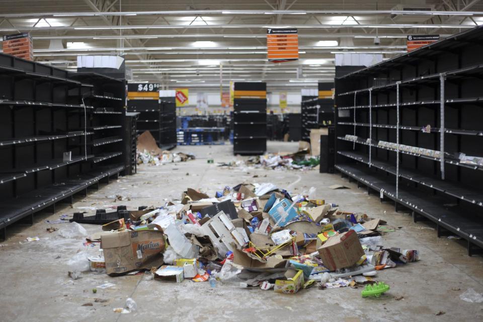 Supermarket displays stand empty and looted following protests caused by a 20 percent hike in gasoline prices, in Veracruz, Mexico, Saturday, Jan. 7, 2017. The Interior Department reported that more than 1,500 people have been detained for looting or disturbances nationwide since protests began early in the week. (AP Photo/Felix Marquez)