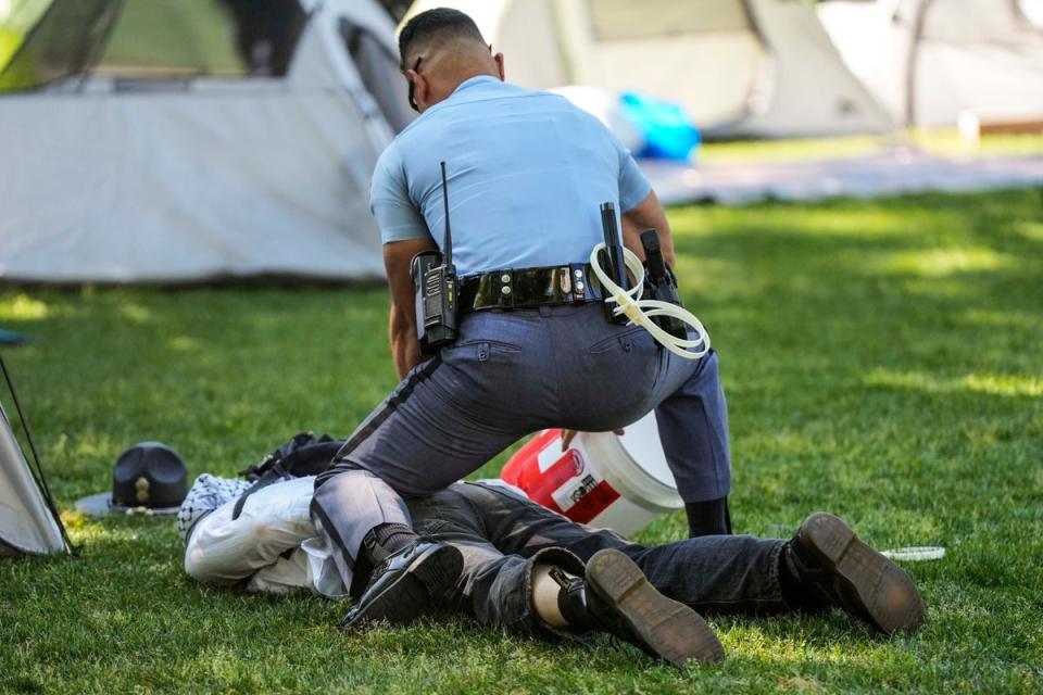 A Georgia State Patrol officer detains a protester on the campus of Emory University (AP)