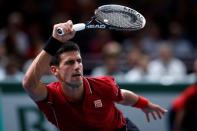 Novak Djokovic of Serbia returns a shot during his men's singles tennis match against Gael Monfils of France in the third round of the Paris Masters tennis tournament at the Bercy sports hall in Paris, October 30, 2014. REUTERS/Benoit Tessier
