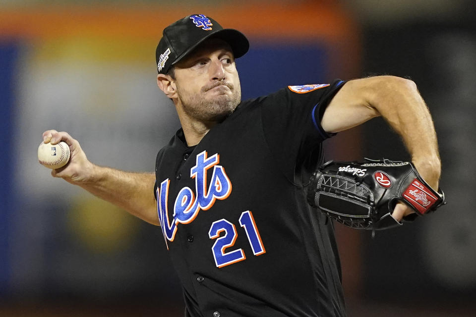 New York Mets starting pitcher Max Scherzer (21) delivers against the San Diego Padres during the first inning of Game 1 of a National League wild-card baseball playoff series, Friday, Oct. 7, 2022, in New York. (AP Photo/John Minchillo)