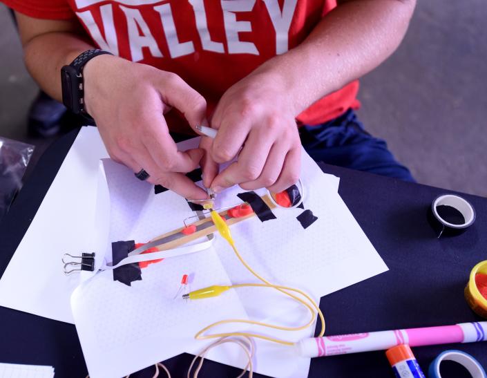 Licking Valley senior Daniel McNeal works on a paper circuit project at Intel's booth at the Hartford Independent Fair on Wednesday, Aug. 10, 2022 at the Hartford Fairgrounds. Intel will host a both from 3 p.m. - 8 p.m. through Friday with stem activities, information, and other activities for Licking County families.