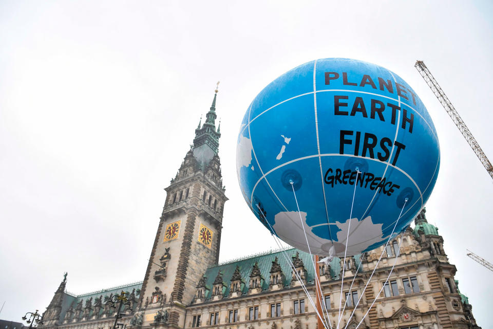 <p>A balloon is lifted in front of the Hamburg city hall (Rathaus) during a demonstration called by several NGOs ahead of the G20 summit in Hamburg on July 2, 2017. (John MacDougall/AFP/Getty Images) </p>