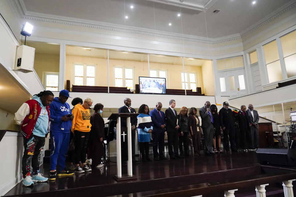 Family and supporters of Tyre Nichols, who died after being beaten by Memphis police officers, bow in prayer at the start of a news conference with civil rights Attorney Ben Crump in Memphis, Tenn., Monday, Jan. 23, 2023. (AP Photo/Gerald Herbert)