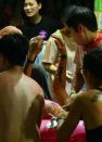 People carry an injured man after an explosion at the Formosa Fun Coast amusement park in the Pali district of New Taipei City on June 27, 2015