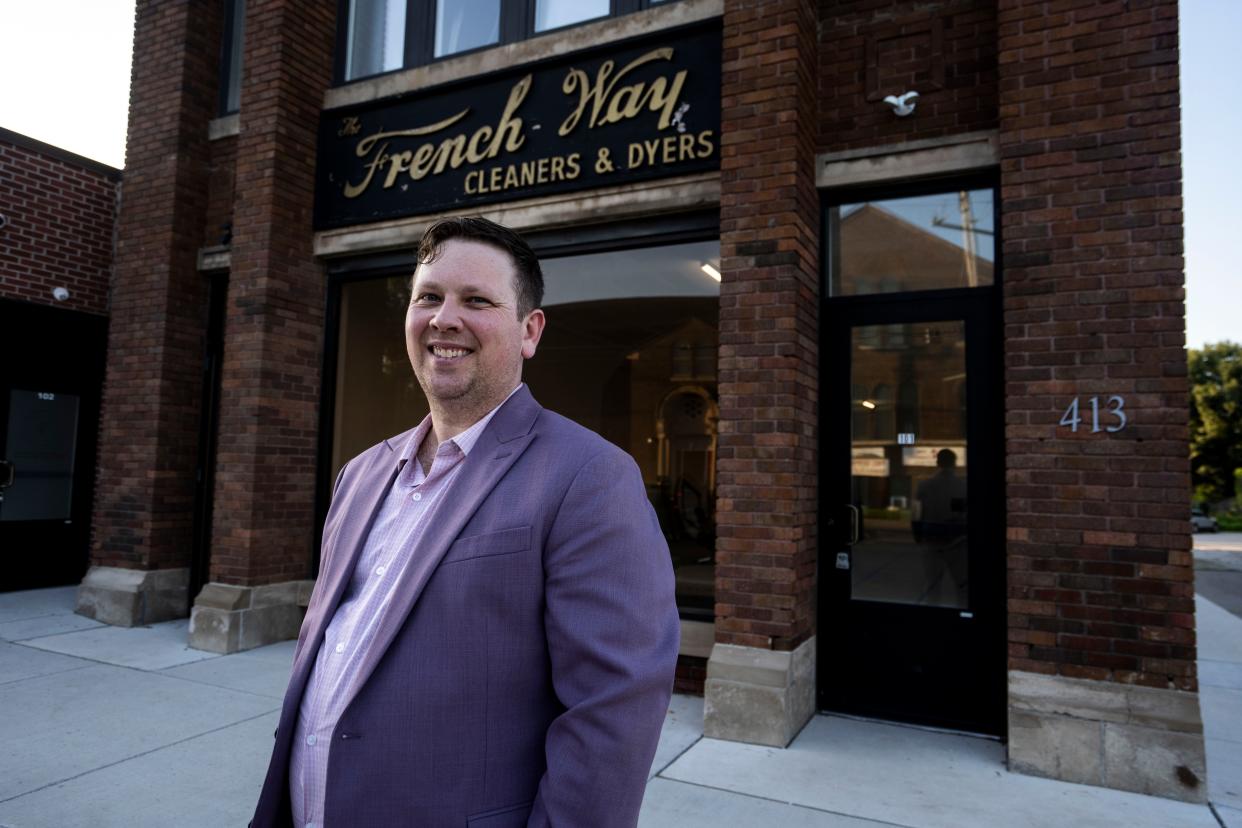 Joshua Law of Des Moines Movers and Shakers in front of the former French Way Cleaners building in the Highand Park neighborhood of Des Moines.