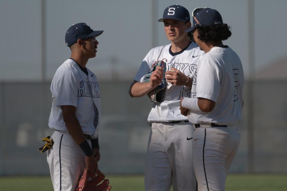 Silverado’s Uriel Martin, Jace Weiss, and Anthony Lupercio talk on the mound during the fifth inning against Victor Valley on Tuesday, April 23, 2024 in Victorville. Silverado defeated Victor Valley 9-8.