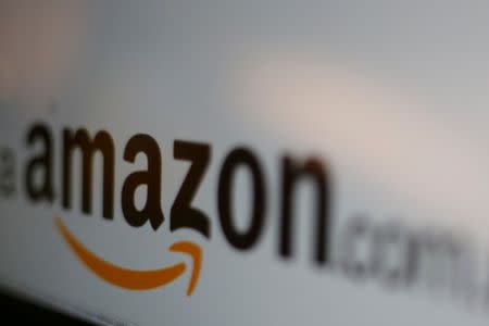 FILE PHOTO: The logo of the web service Amazon is pictured in this June 8, 2017 illustration photo. REUTERS/Carlos Jasso/Illustration/File Photo