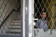 Rohingya refugee and activist Zafar Ahmad Abdul Ghani and his wife look out from their home in Kuala Lumpur