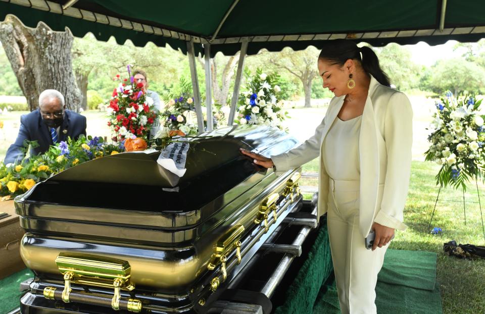 Ashley Caldwell says a last goodbye to her father at the interment of Shreveport City Marshal Charlie Caldwell Jr.