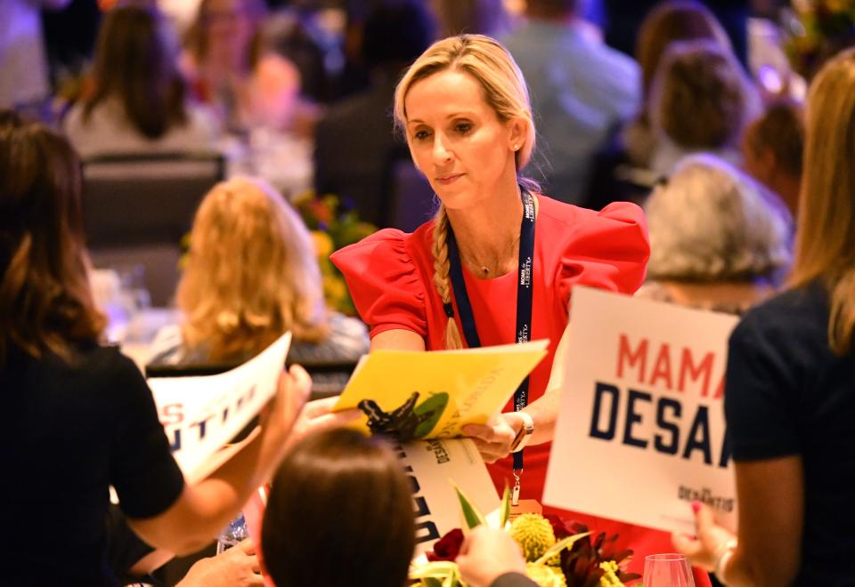 Campaign signs for Florida Gov. Ron Desantis are passed out before the start of the first Moms for Liberty National Summit on Thursday, July 15, 2022 in Tampa, Florida. The convention continues through Sunday, July 17th with conservative speakers and strategy sessions for members.  