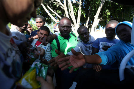 Haitian migrants ask for food outside Padre Chava shelter after leaving Brazil, where they sought refuge after Haiti's 2010 earthquake, but are now attempting to enter the U.S., in Tijuana, Mexico, October 3, 2016. REUTERS/Edgard Garrido