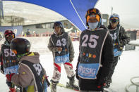 Sekholo Ramonotsi, 13, wearing the number 43, waits for results during the Winter Whip Slopestyle snowboard and ski competition at the Afriski ski resort near Butha-Buthe, Lesotho, Saturday July 30, 2022. While millions across Europe sweat through a summer of record-breaking heat, Afriski in the Maluti Mountains is Africa's only operating ski resort south of the equator. It draws people from neighboring South Africa and further afield by offering a unique experience to go skiing in southern Africa. (AP Photo/Jerome Delay)