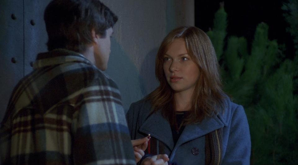 Donna looks up at Eric in awe as he presents her with an engagement ring on the water tower