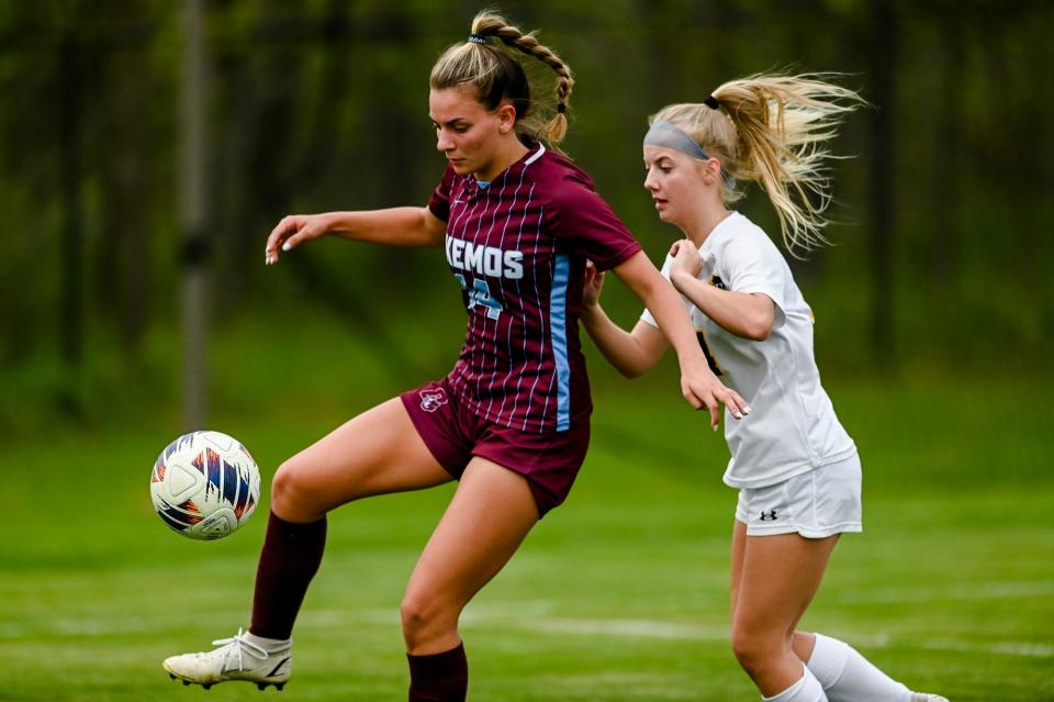 Okemos' Abby Jager, left, controls the ball as DeWitt's Julia Fowler closes in during the second half on Tuesday, May 16, 2023, at Okemos High School.